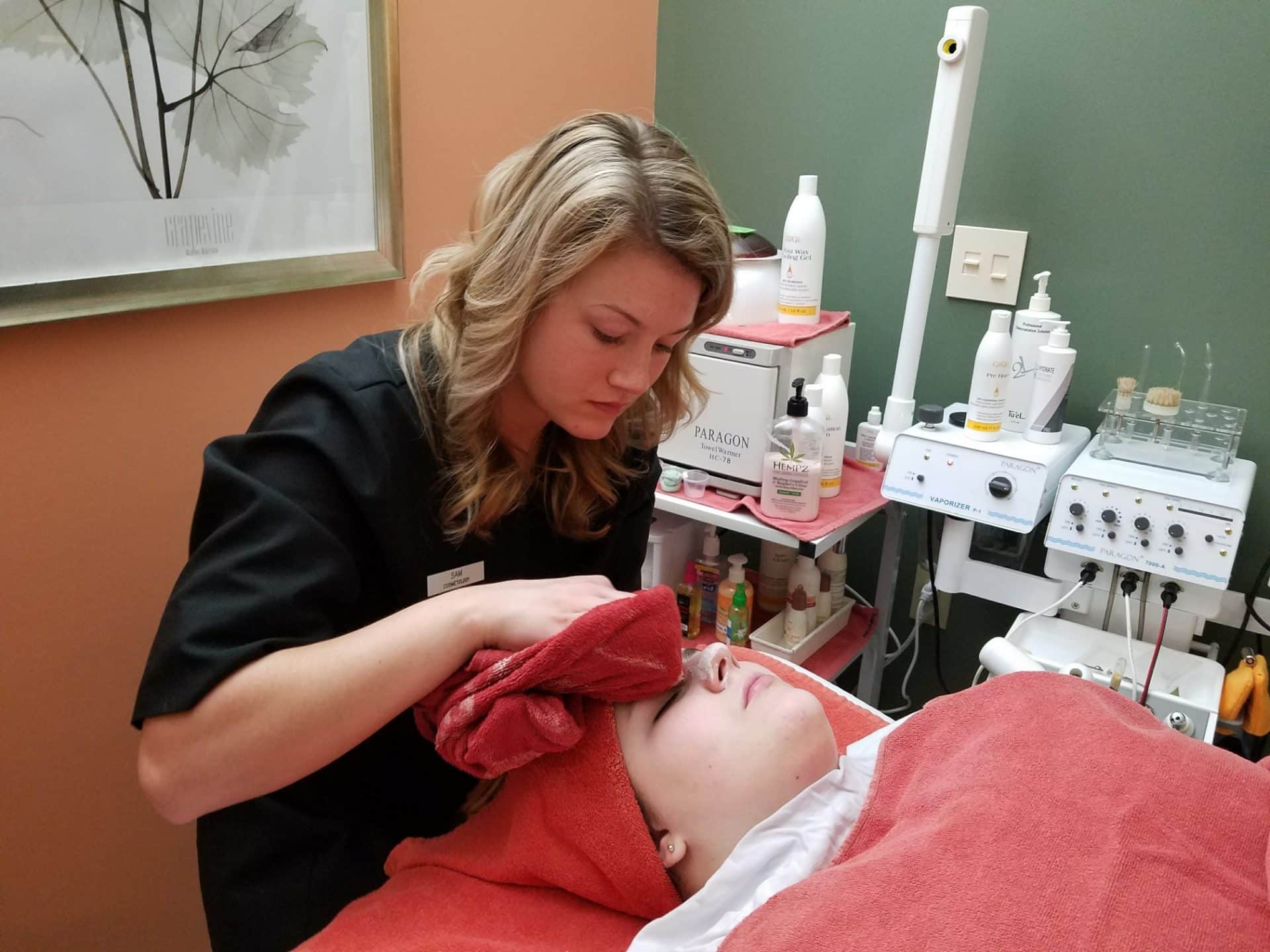 student sam working with another student on facial 