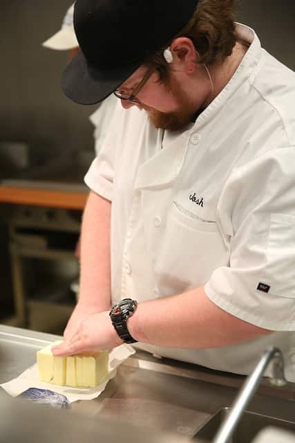 culinary student chopping butter