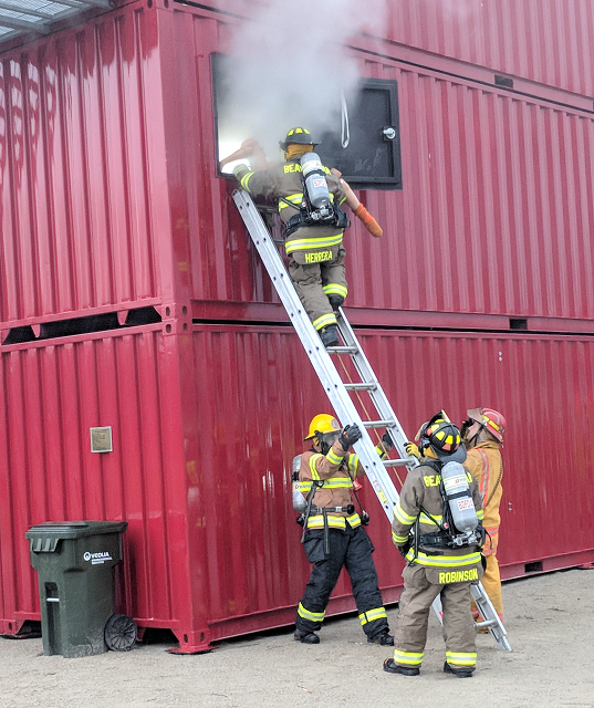 Firefighter students on ladder practicing skills