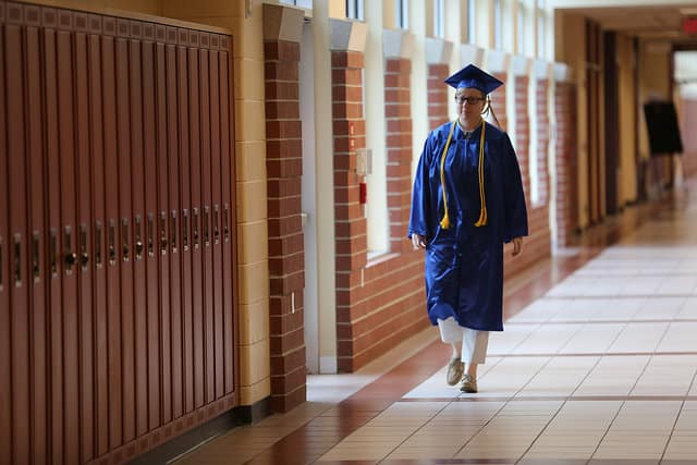 graduate walking down the hallway