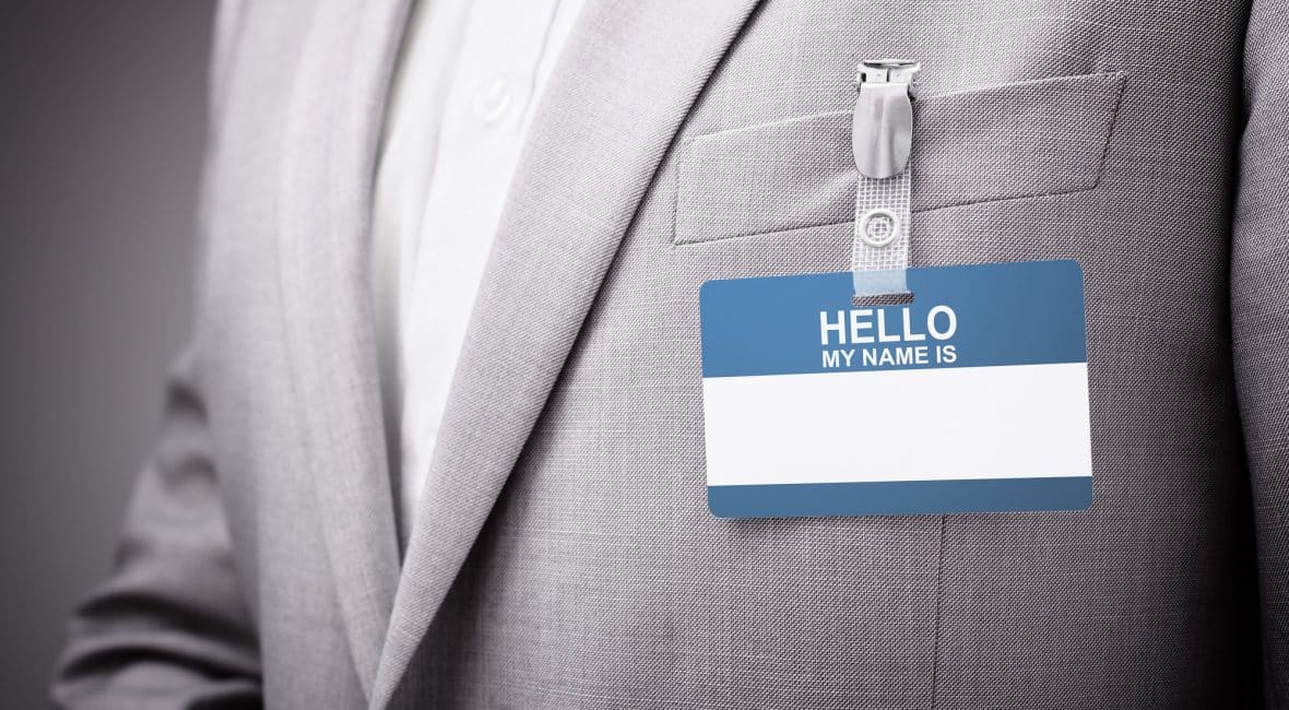 Businessman at an exhibition or conference wearing a Hello my name is security identity name card or tag